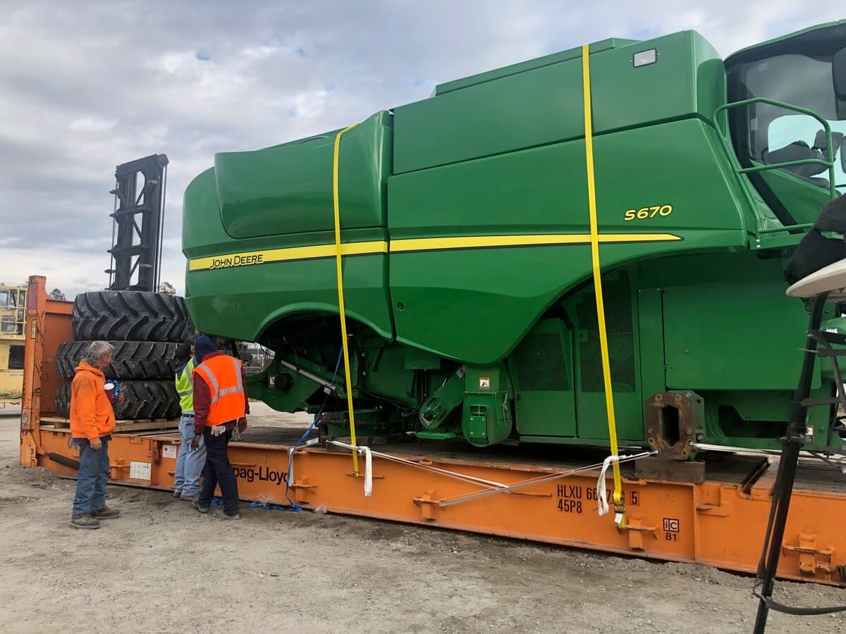 Meridian Freight crew in front of a John Deere S670 combine at the Albion, Iowa facility
