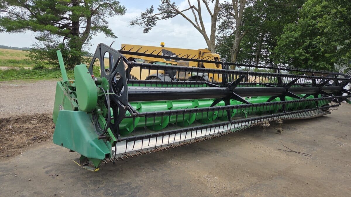 John Deere 930F flex grain header standing in the yard at our Albion, Iowa warehouse, reel and cutter bar visible