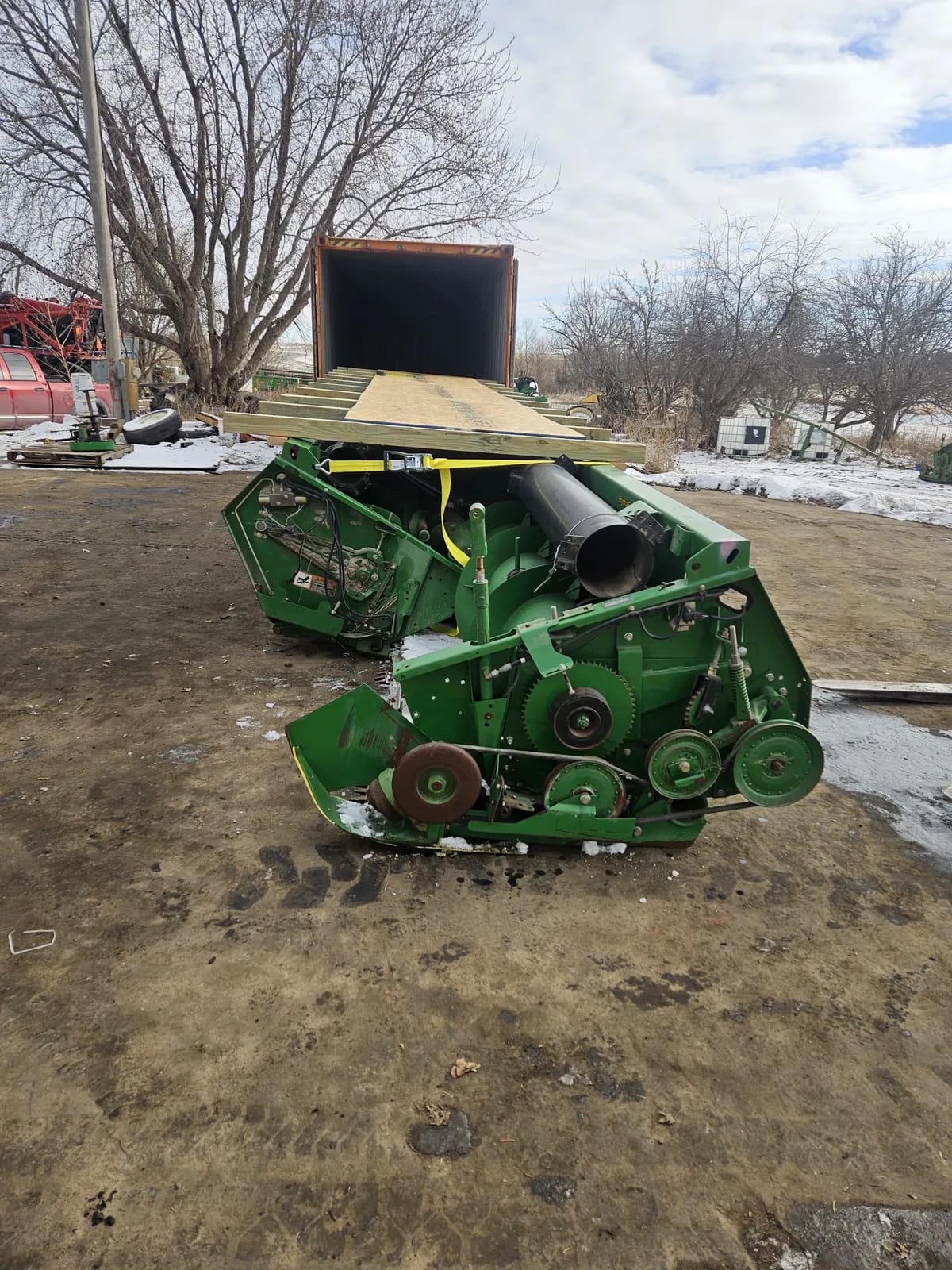 Header on the ground with a wooden deck laid over it, lined up with an open container