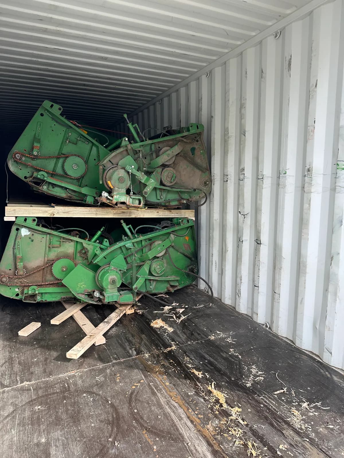 Inside a container: green headers in an upper and a lower tier with a timber deck between them